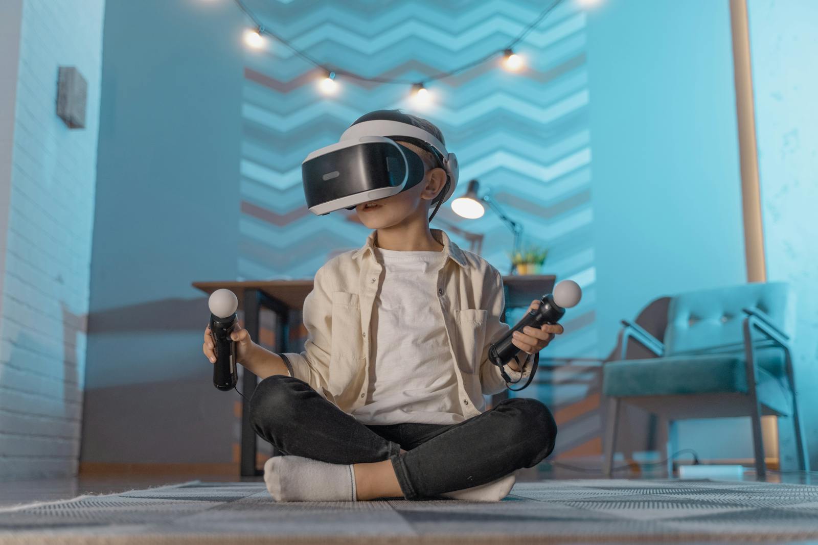 Young boy sitting and playing with VR goggles in a cozy room setting.